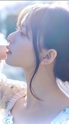 Woman with long hair in soft backlight, looking up