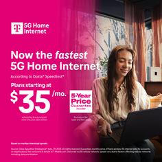 Woman with long hair sitting indoors and using a laptop
