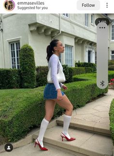 Woman in a denim skirt and red heels walking up outdoor stairs