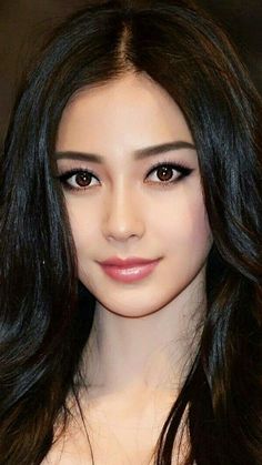Woman with long black hair and brown eyes looking directly at the viewer