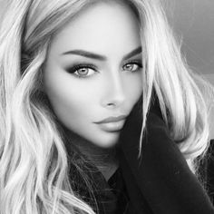 Woman with long wavy blonde hair in a black and white close-up portrait