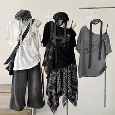 Three mannequins displaying dark aesthetic streetwear outfits