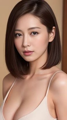 Woman with short brown hair wearing a light-colored top, upper body portrait