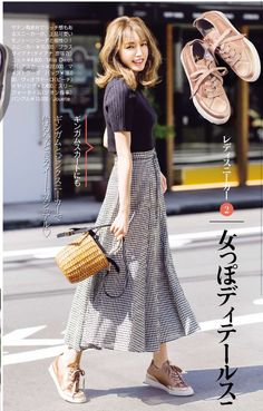 Woman in a black top and gingham skirt with a wicker bag and sneakers