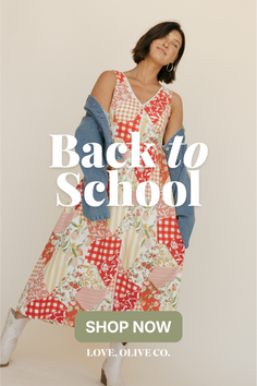 Woman in a patchwork dress and denim jacket posing in a studio