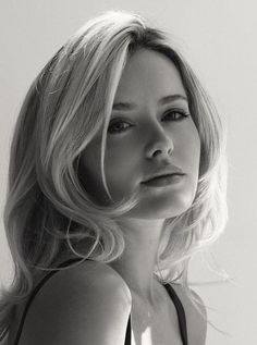 Blonde woman with long hair in a black and white portrait with soft lighting