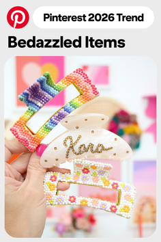 Hand holding three bedazzled hair clips with colorful beads and patterns
