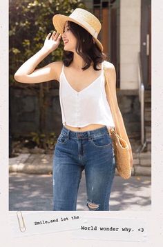 Woman in a straw hat, white camisole, and blue jeans outdoors