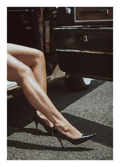 Woman's legs in high heels stepping out of a car