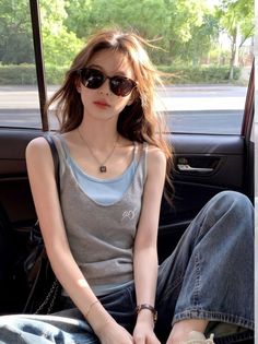 Woman with long hair and sunglasses in a car