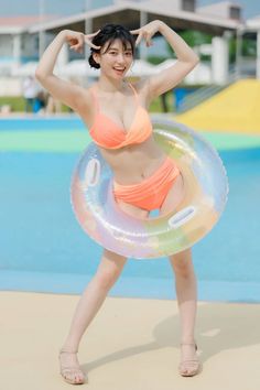 Woman in an orange bikini with a swim ring at a water park
