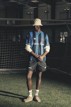 Person in a soccer jersey and bucket hat on an indoor soccer field