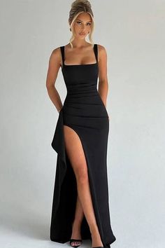 Woman in a black dress with a high slit and an updo hairstyle