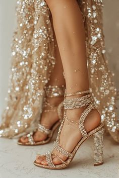 Woman's legs in sparkling high heels and a glittery dress