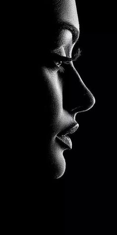 Black and white profile of a face with dramatic lighting and high contrast