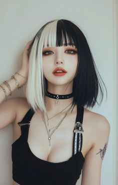Woman with split black and white hair, dark makeup, and a choker