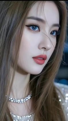 Woman with long hair and blue eyes wearing a sparkling top and choker