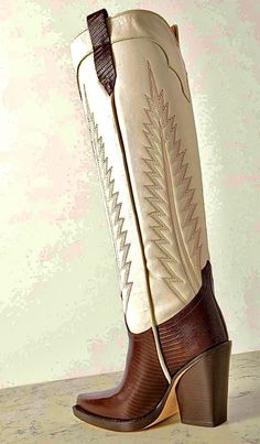 Brown and white cowboy boot with embroidered design and high heel