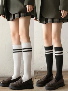Two people in school uniforms with knee-high socks and loafers