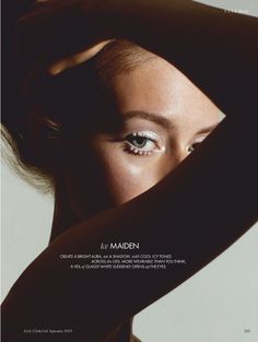 Close up of a woman's eye with white eyeliner and pearls, dramatic lighting