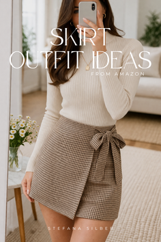 Woman in a turtleneck sweater and plaid skirt taking a mirror selfie
