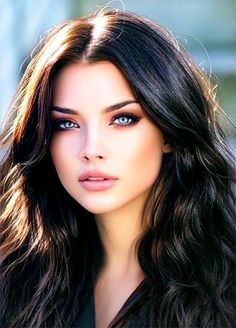 Woman with long dark hair and blue eyes in a close-up portrait