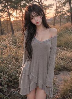 Woman with long dark hair in an off-shoulder ruffle dress outdoors at golden hour