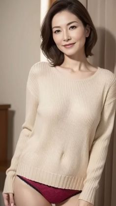 Woman in a beige sweater and red underwear posing indoors