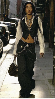 Woman with braided hair and baggy jeans walking on a street