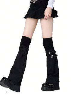 Person in a black skirt, leg warmers, and platform shoes on a white background