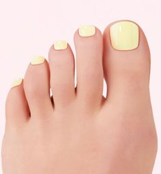 Close up of toes with bright yellow nail polish