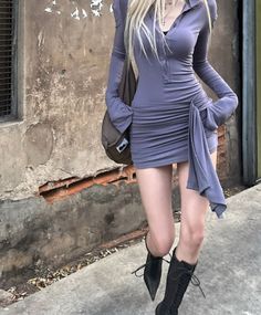 Woman in a tight long-sleeve dress and lace-up boots outdoors
