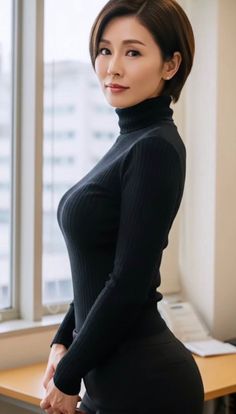 Woman with short hair wearing a black turtleneck indoors