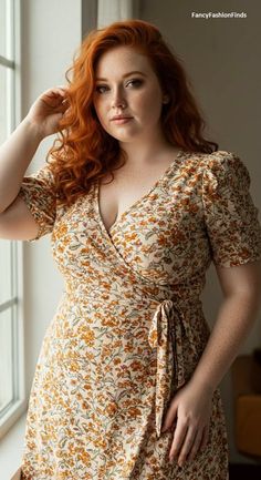 Woman with red hair and freckles wearing a floral wrap dress indoors