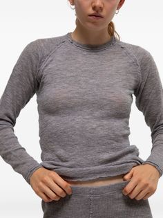 Woman in a sheer gray long-sleeve top and matching bottoms