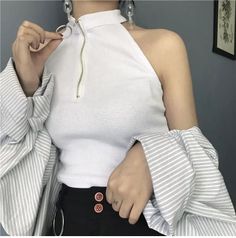 Woman in a white top with striped sleeves and an exposed shoulder