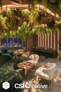 A modern rooftop bar with lush greenery and a cityscape view at night