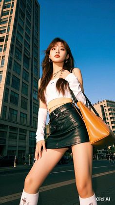 Woman in a white crop top and black leather skirt posing outdoors