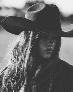 Woman wearing a cowboy hat with long hair in a black and white portrait