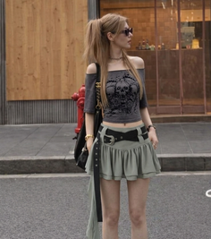 Woman in an off-shoulder top and mini skirt with a ponytail on a street