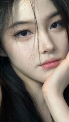 Close up portrait of a woman with long black hair and soft lighting