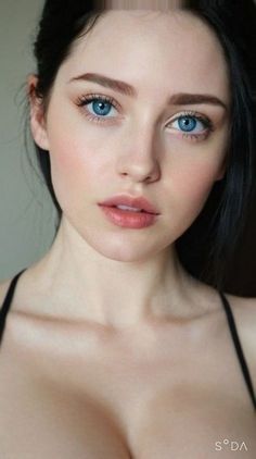 Woman with blue eyes and black hair in a close-up portrait