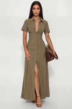 Woman in a long olive green dress with open buttons and a brown clutch