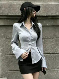 Woman in a tight shirt and mini skirt with a black cap outdoors