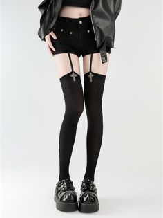 Person in black shorts, thigh-high stockings with garter straps, and platform shoes