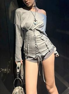 Woman in an off-shoulder top with a corset and short shorts