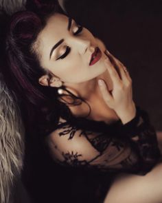 Woman with pin-up hair and red lipstick in a black lace top