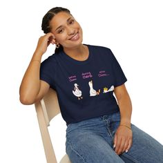 Woman in a dark blue t-shirt and jeans with a goose illustration