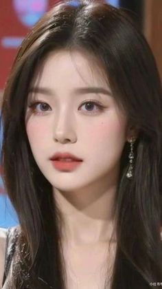 Woman with long black hair and earrings in a close-up portrait