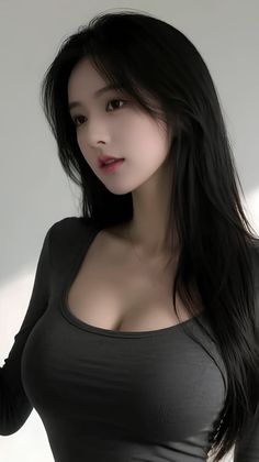 Woman with long black hair wearing a tight top with cleavage
